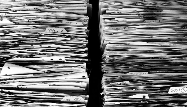 two stacks of paper/files in black and white