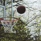 a basketball arcing into the net