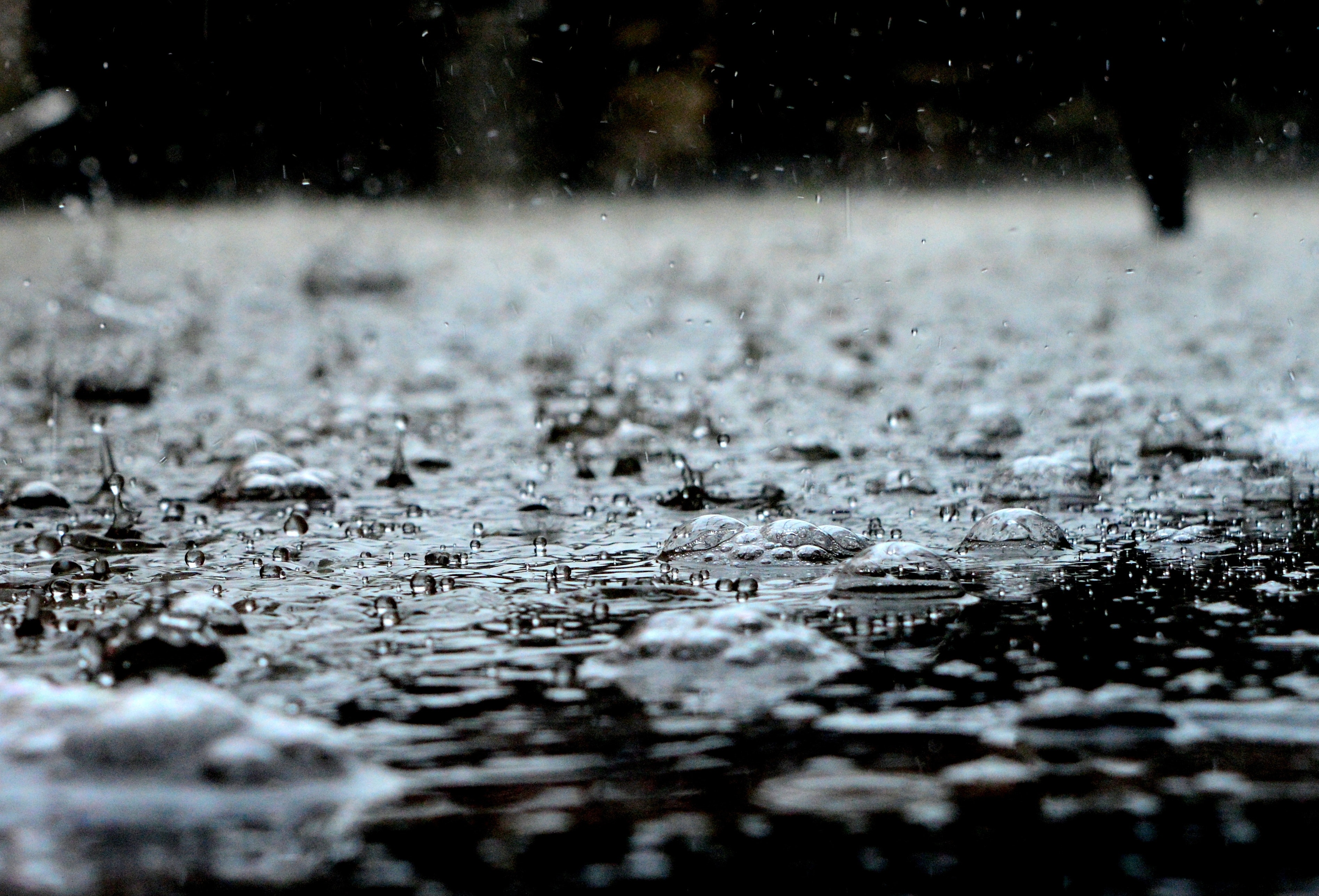 Close-up image of rain hitting the street