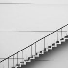 Photograph of a white, sleek staircase