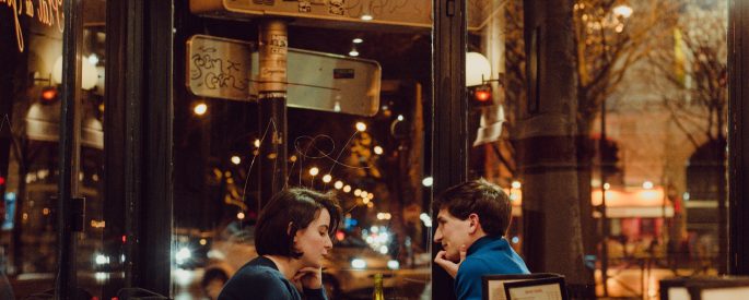 Image of a couple sitting at a table in a bar