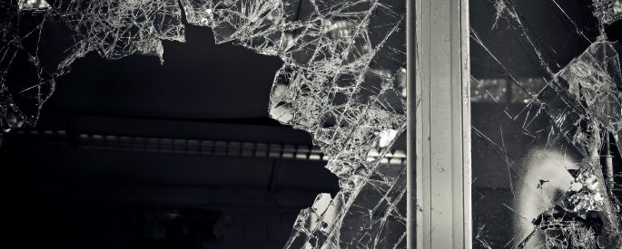 Black and white photo of a broken window