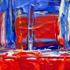 A photograph of an abstract painting with lots of reds and blues.