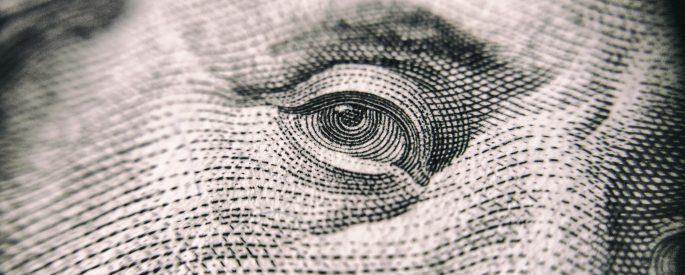 Closeup photograph if the eye on a US dollar bill