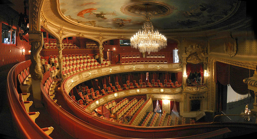 Photograph of the gold and red details of the inside of a theater