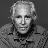 black and white headshot portrait of Gordon Lish, who looks directly at the camera