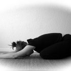 black and white photo of a woman doing yoga in child's pose