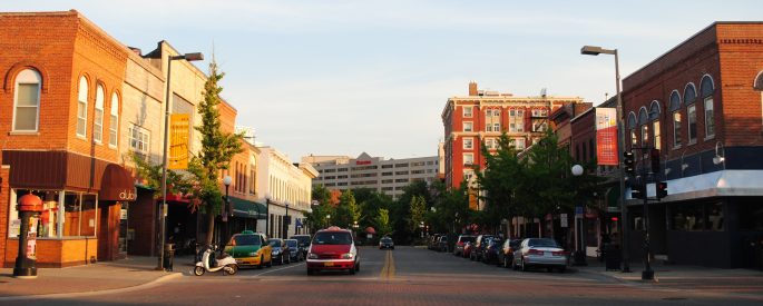 photo of Iowa City at golden hour, with bright golden light strewn across brick buildings