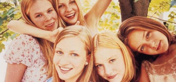 photo of the actresses from the virgin suicides posing together playfully in a tree