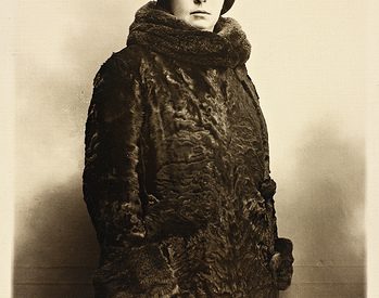 sepia photograph of a woman dressed in a fur cap and a fur coat