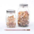 two glass jars containing pencil shavings