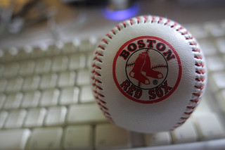 up close photograph of a Boston Red Sox baseball placed ontop of an old keyboard