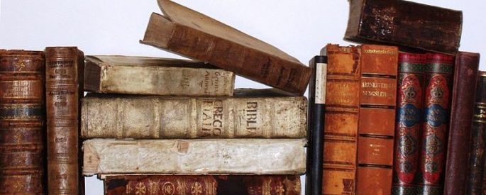 stock photo image of old, antique books stacked on top of each other