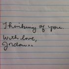 lined paper with the words hand written in cursive: "Thinking of you. With love, Jordan xx"
