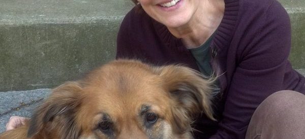 photograph of Ploughshares editor-in-chief Ladette Randolph posing with dog