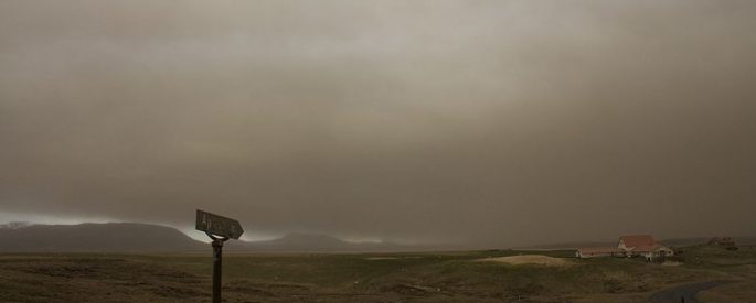 desolate photograph of a gray sky over a barren landscape