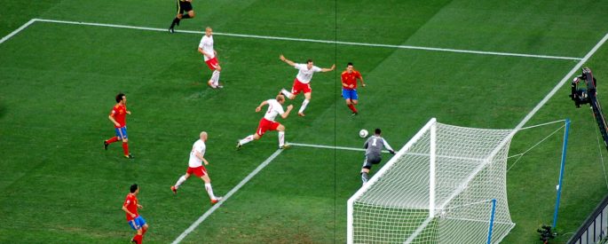 photograph of soccer players during the FIFA 2010 World Cup between Spain and Switzerland celebrate after a goal