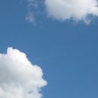 photograph of a bright blue sky with fluffy white clouds