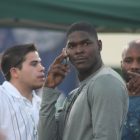 Keyshawn Johnson stands, head turned, as he speaks on the phone--photograph taken by paparazzi
