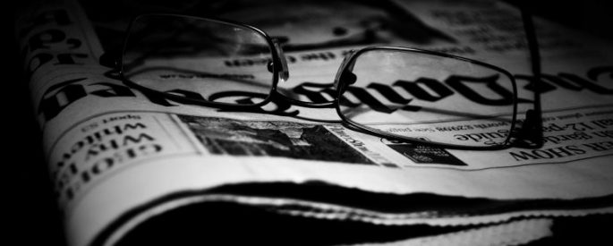 Pair of glasses on a newspaper
