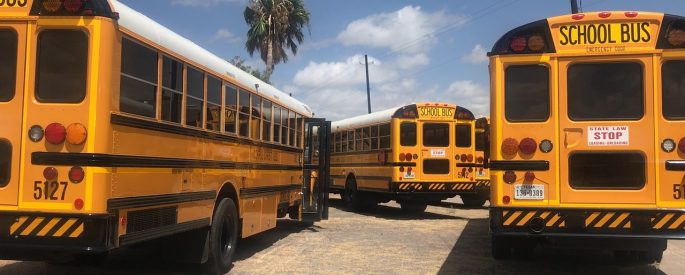 A parking lot of school buses.