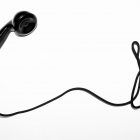 A black telephone on a cord.
