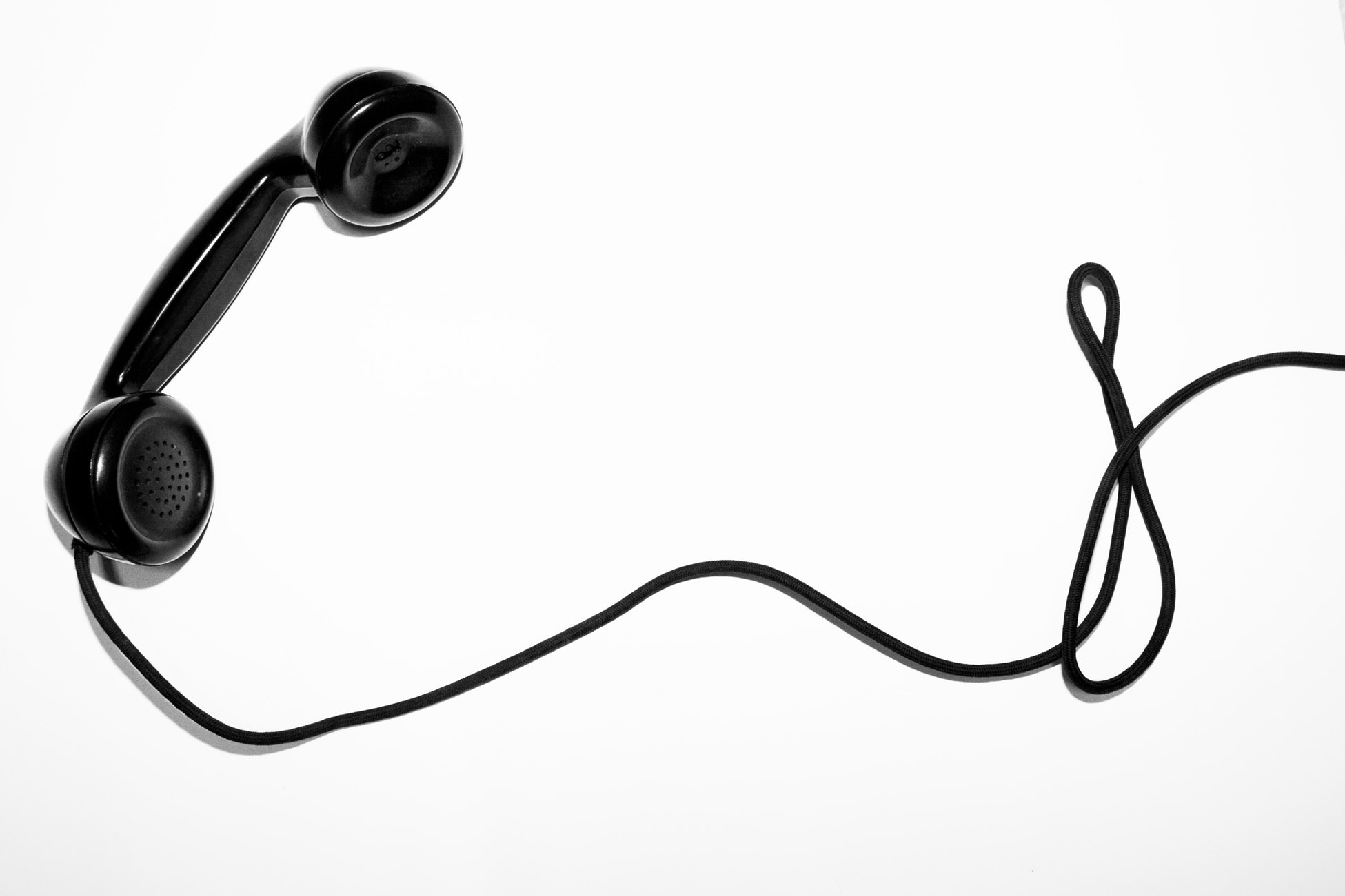 A black telephone on a cord.