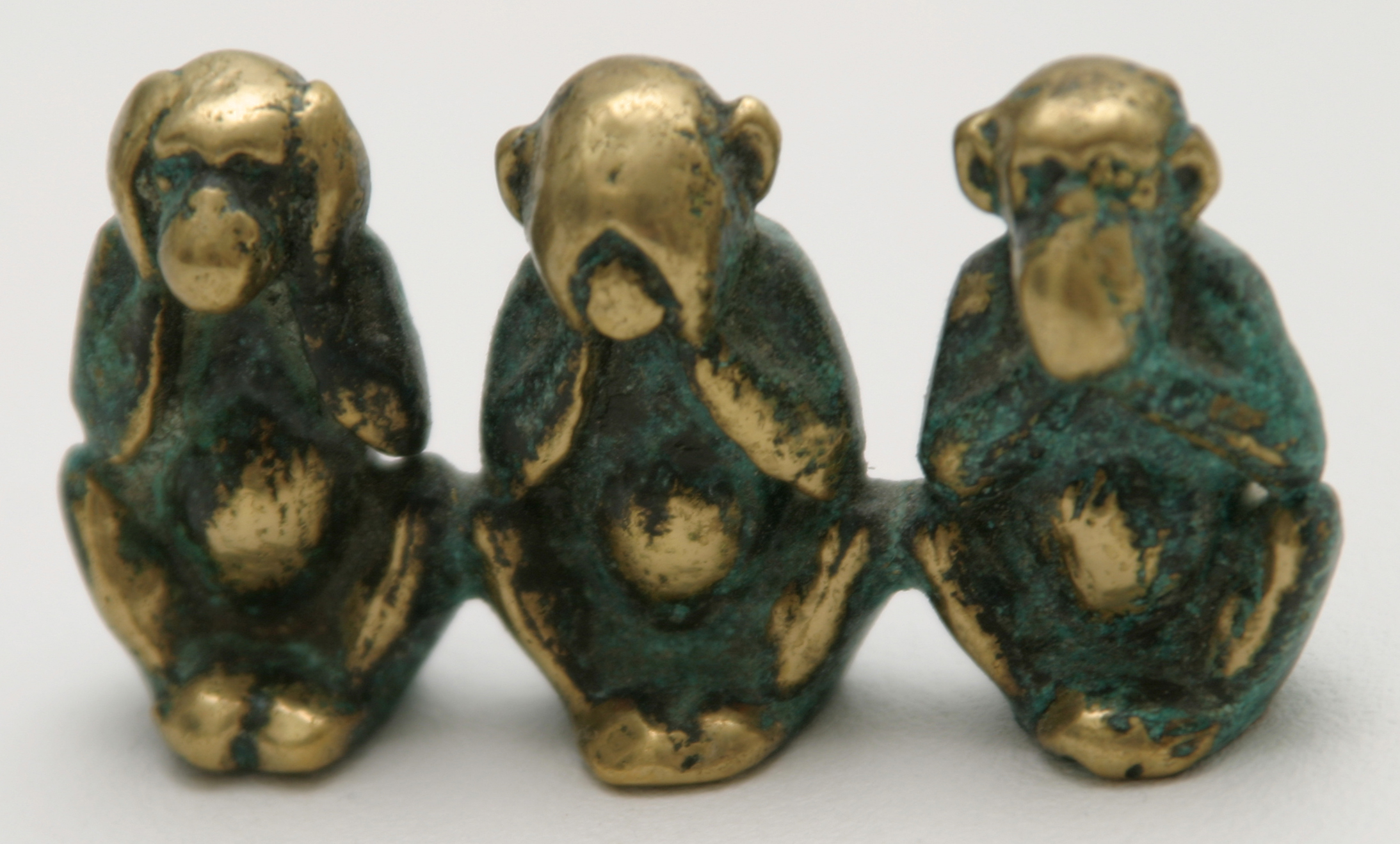 Photo of a tarnished statue of See/Speak/Hear no evil monkeys