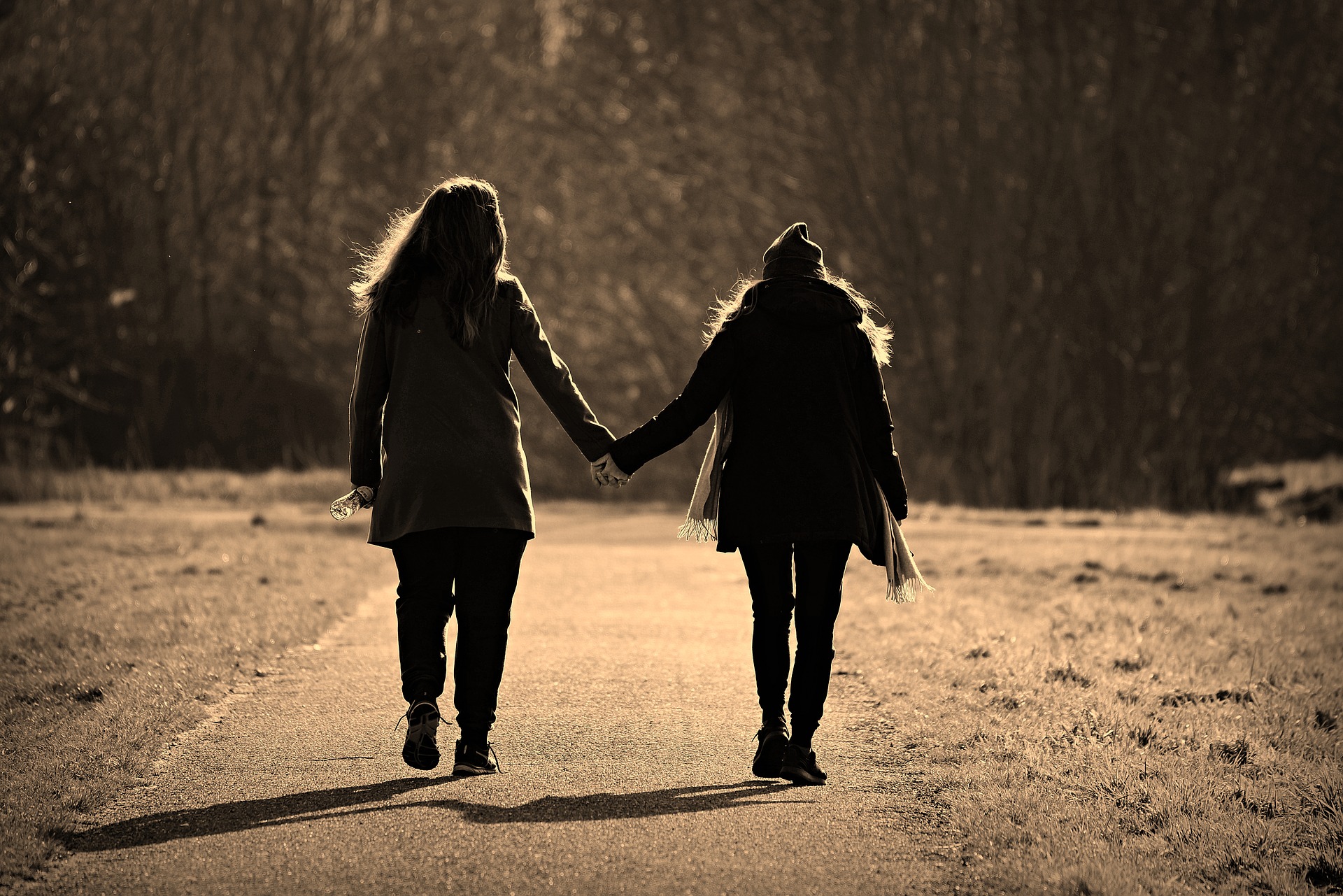 Two women holding hands.