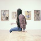 woman sitting on floor in art gallery