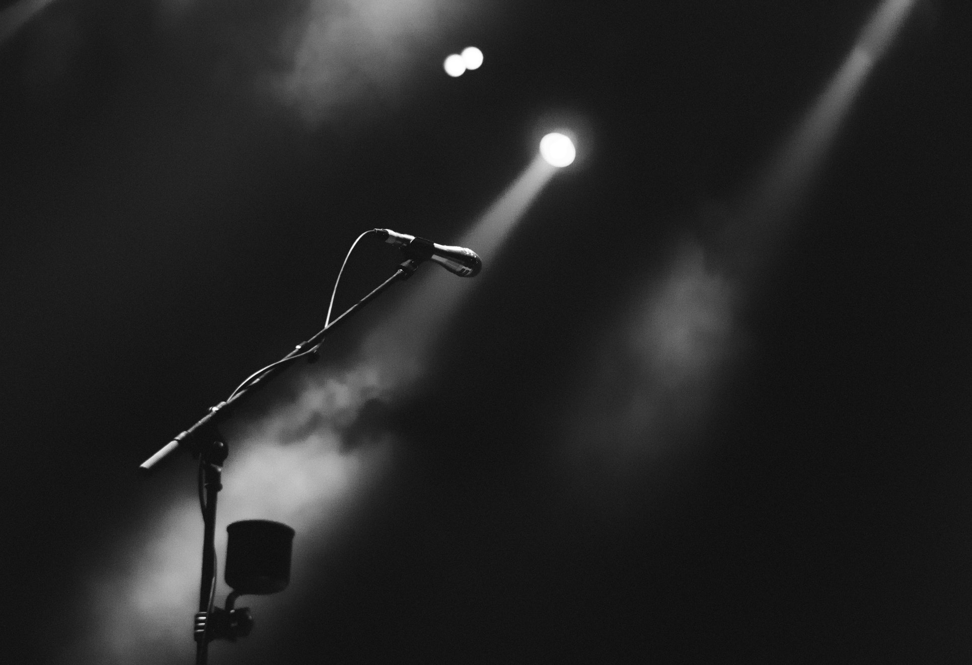 Picture of a microphone centered on foggy stage