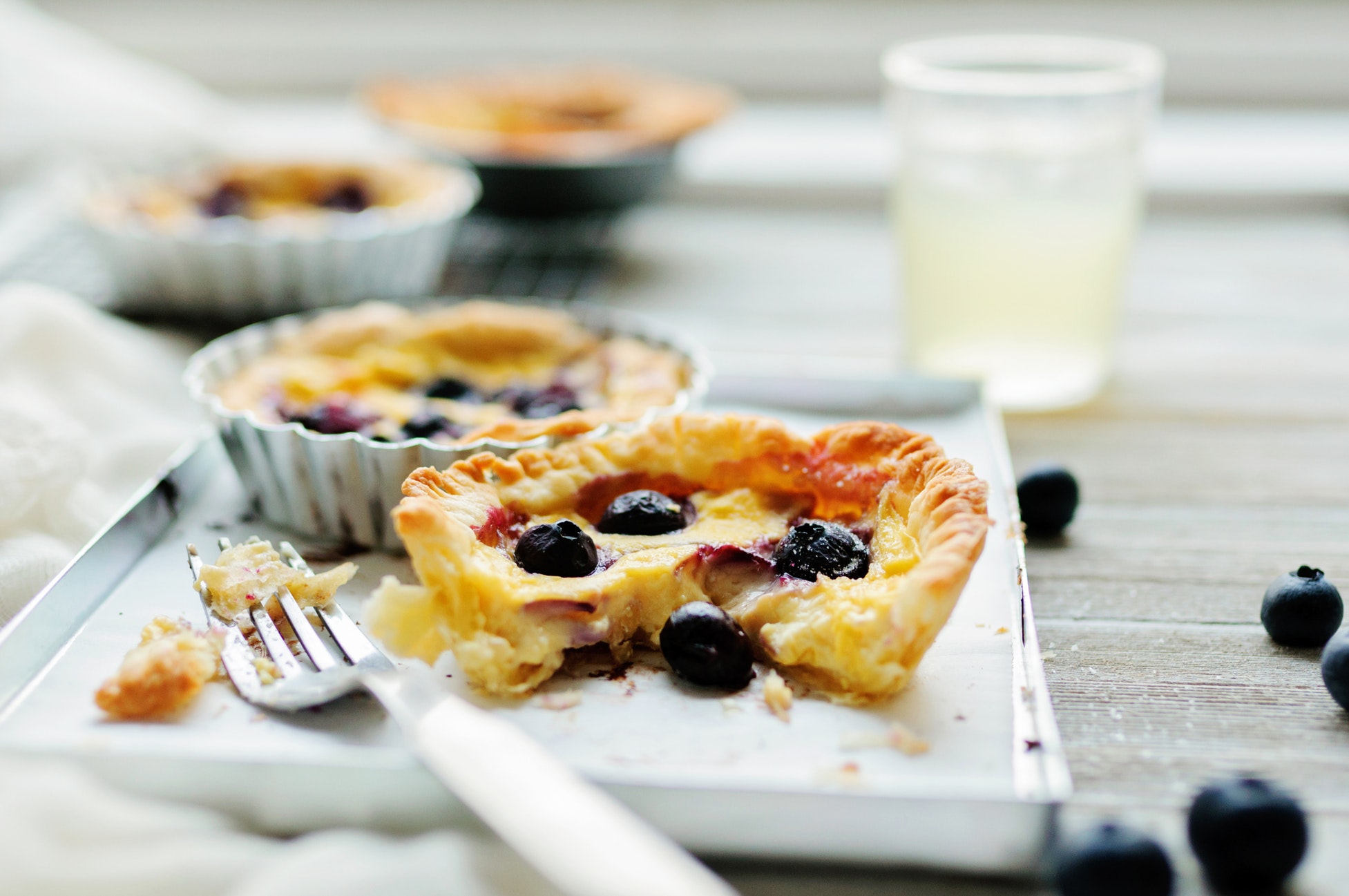 picture of a couple of small pies with berries beside a fork