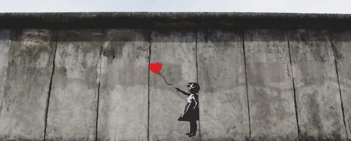 girl playing heart balloon wall artwork