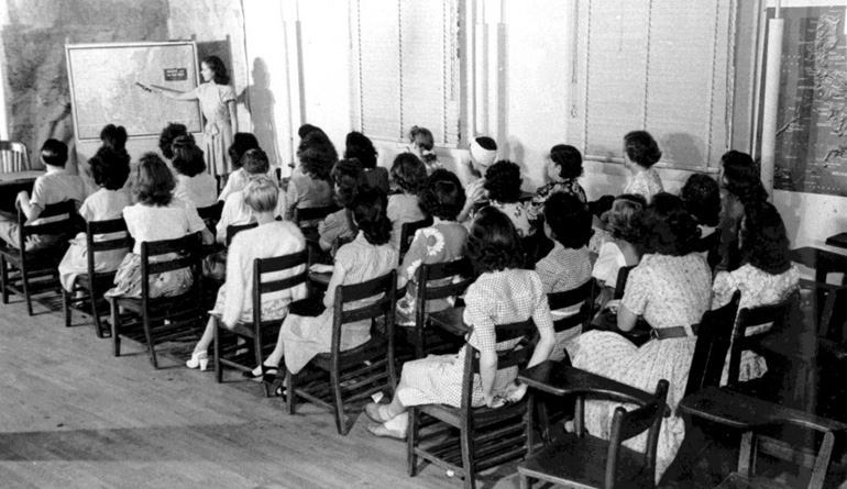 young women learning in classroom; black and white 