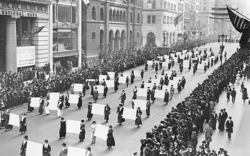 Suffragists parade down Fifth Avenue, 1917. Advocates march in October 1917, displaying placards containing the signatures of more than one million New York women demanding the vote. The New York Times Photo Archives
