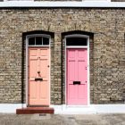 Two doors, orange and pink, in the daylight