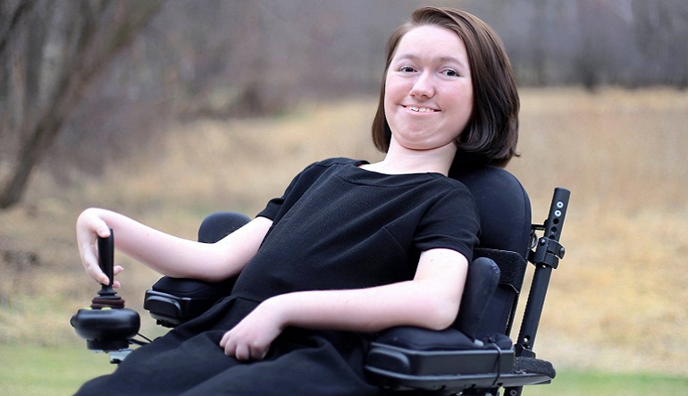 Woman sitting in wheelchair posing for the camera.