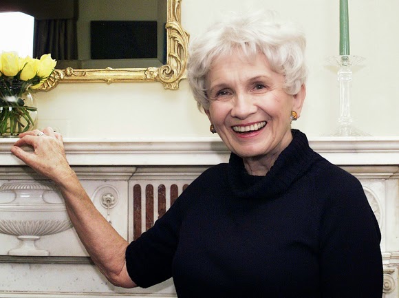 Older woman with white hair posing for the camera in front of a decorated marble wall.