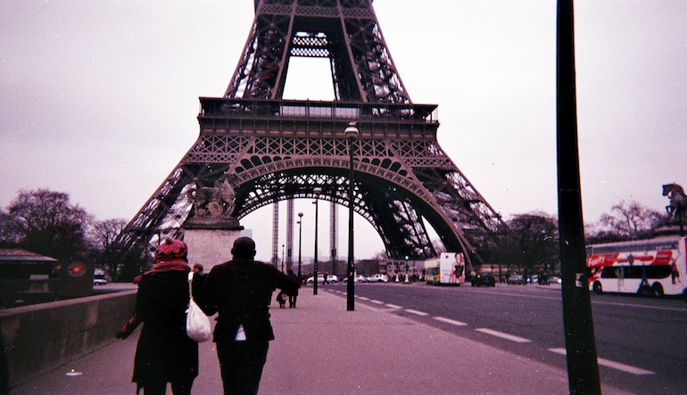 People standing in front of the Eiffel Tower.