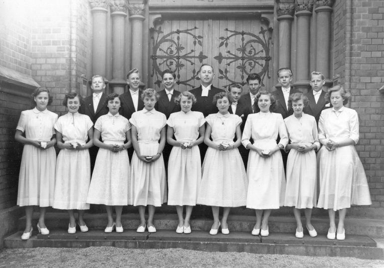 black and white photo of posing young women and men dressed up