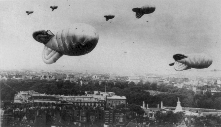 Old photograph of blimps in the sky.