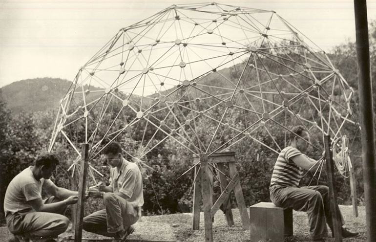 Men working on a wire contraption.