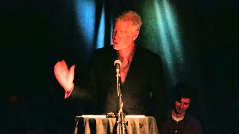 Man speaking at a podium.