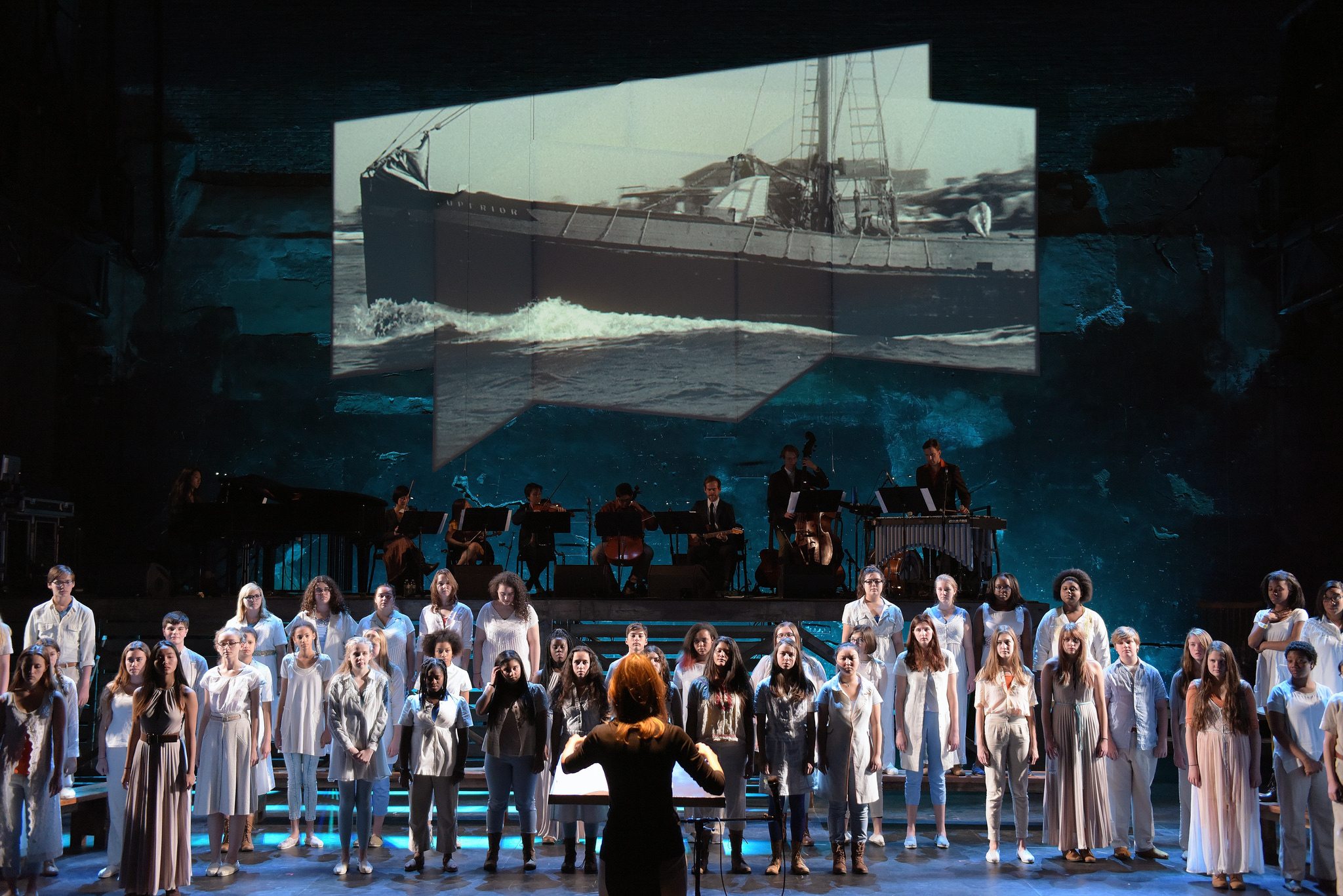 youth choir on stage with musicians and ship backdrop