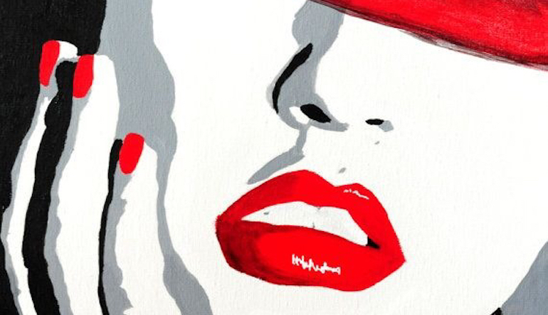 close up of a woman's face and hand, with red lipstick and red painted fingernails 