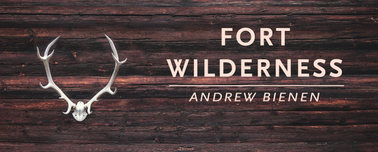 A piece of wood with antlers attached and the text "Fort Wilderness by Andrew Bienen"
