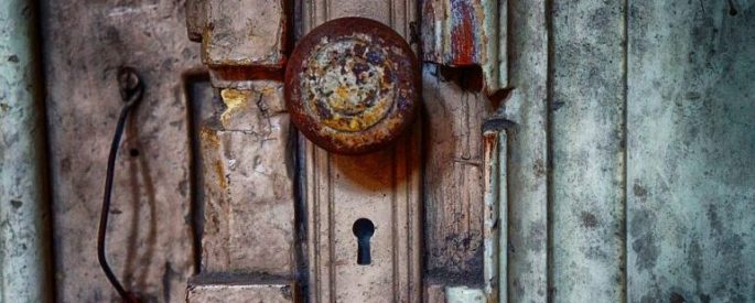 old doorknob crusted in color, a keyhole underneath