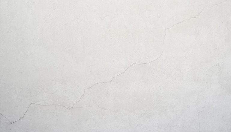a thin crack in a white-ish wall