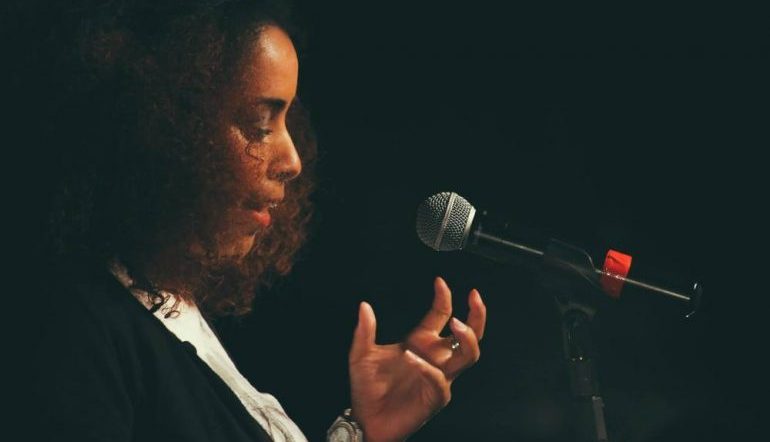 Jasminne Mendez at a microphone
