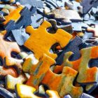 unmatched jigsaw puzzle pieces, in orange, blue, and green